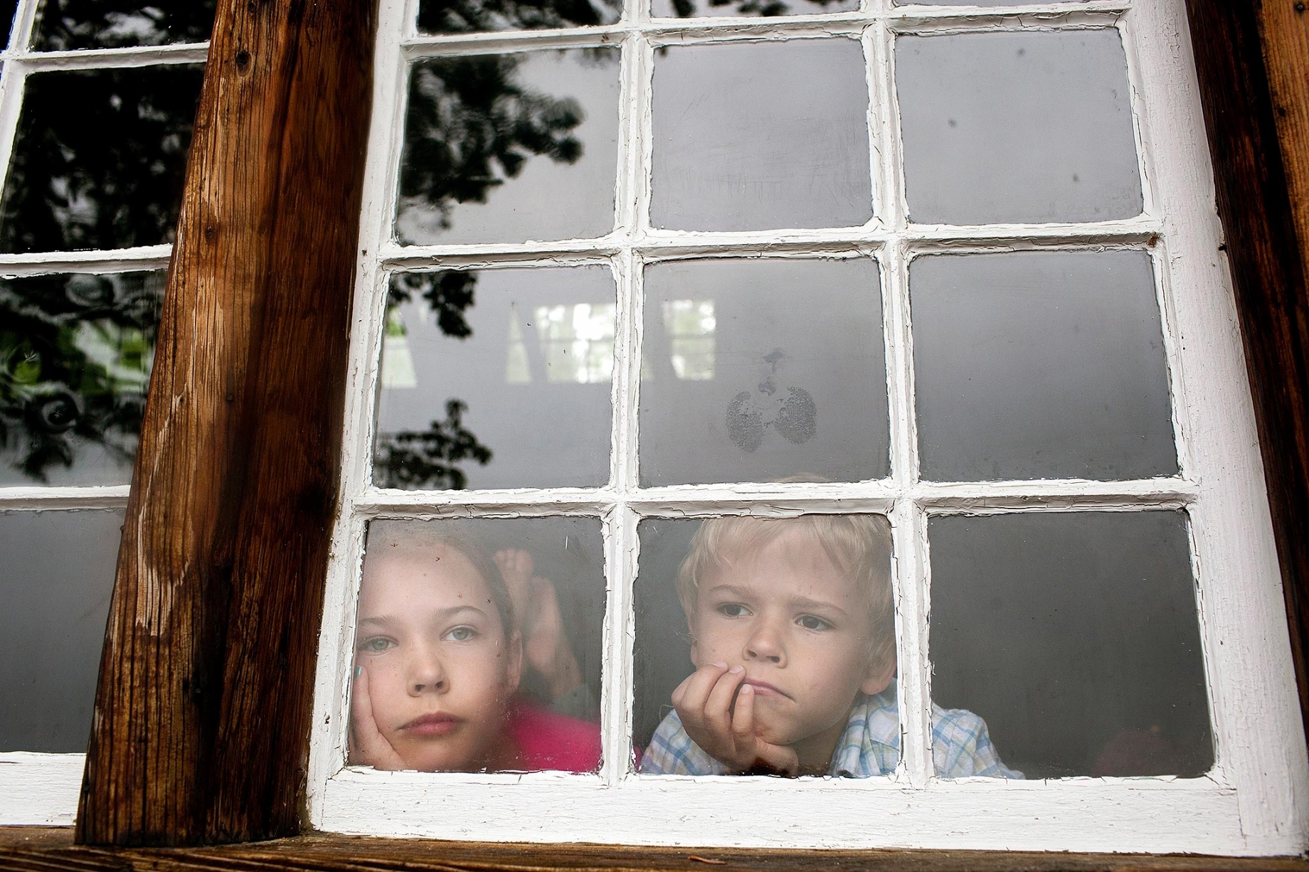 Children looking through window